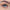 A close-up image of a blue eye with long eyelashes showcases the Ardell Naked Lashes 420 Multipack for added allure. The eyelid is adorned with black eyeliner, and the eyebrow is neatly groomed. The eye gazes directly ahead, highlighting the intricate details of this cruelty-free lash look from Ardell.