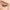 Close-up of a person's face with an eye closed, showcasing long, dark Ardell Faux Mink Lashes Black Demi Wispies and a neatly groomed eyebrow. The skin appears smooth and flawless, highlighting the natural beauty of the lashes.