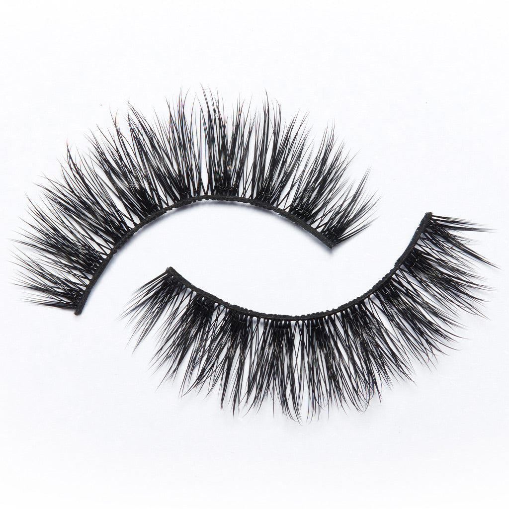 The Eylure Most Wanted Lashes - Gimme Gimme feature two pairs of dramatic black false eyelashes with dense, long fibers arranged in curved shapes on a white background, delivering extreme volume. These vegan-friendly lashes by Eylure ensure a bold yet ethical statement for any look.