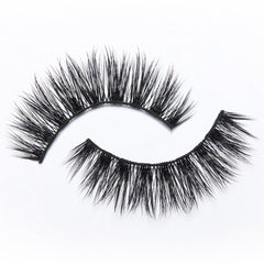 The Eylure Most Wanted Lashes - Gimme Gimme feature two pairs of dramatic black false eyelashes with dense, long fibers arranged in curved shapes on a white background, delivering extreme volume. These vegan-friendly lashes by Eylure ensure a bold yet ethical statement for any look.