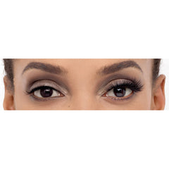 A close-up of a person's eyes shows well-defined eyebrows and dramatic makeup, featuring metallic eyeshadow and Eylure Most Wanted Lashes - Gimme Gimme for extreme volume. This combination creates a bold and elegant look that is also vegan-friendly.