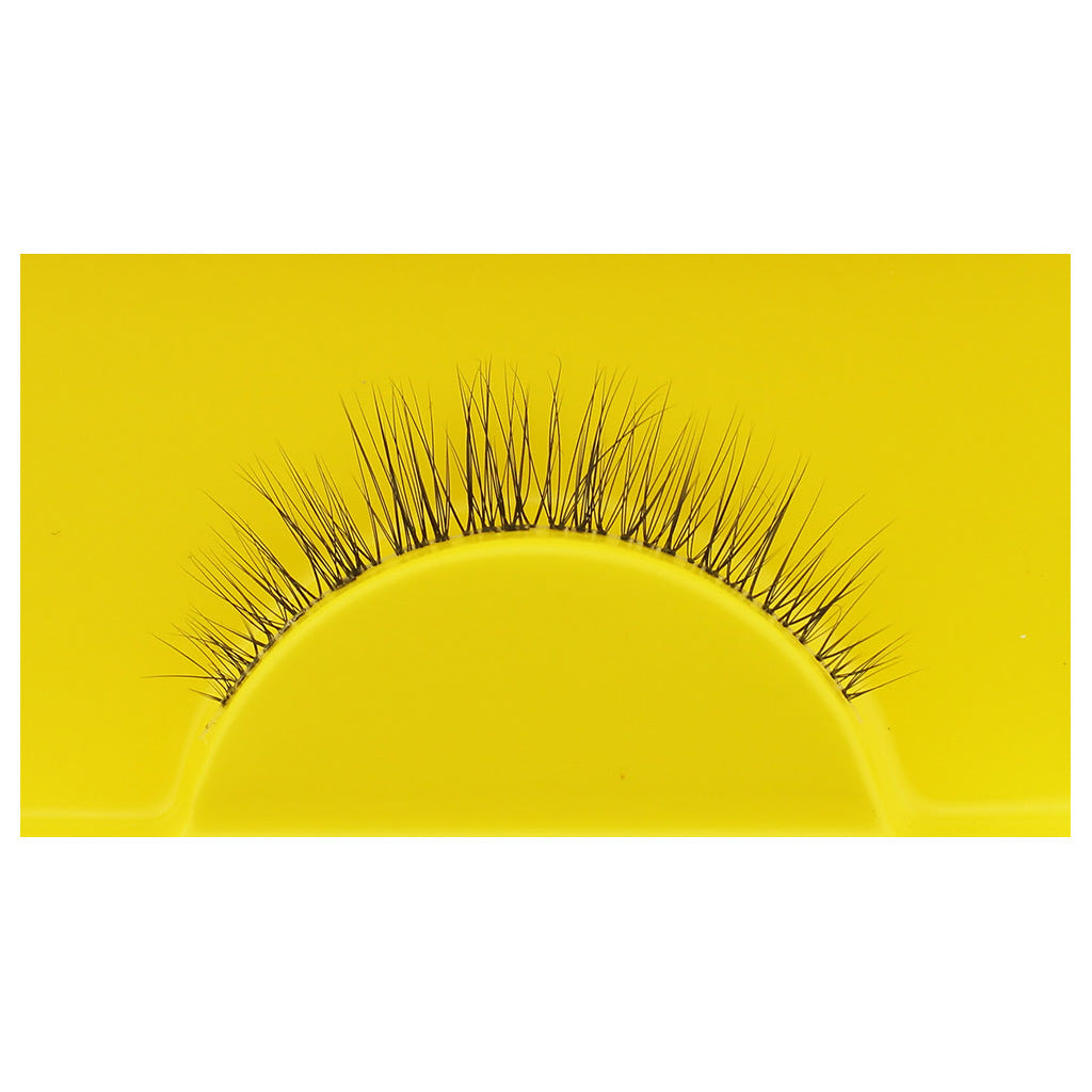 A single Boldface Lashes - Short and Sweet false eyelash rests on a vibrant yellow background. This cruelty-free beauty by Boldface showcases fine, evenly spaced black fibers arranged in a natural curve, enhancing the appearance of eyelashes when worn while ensuring this accessory is both captivating and kind.