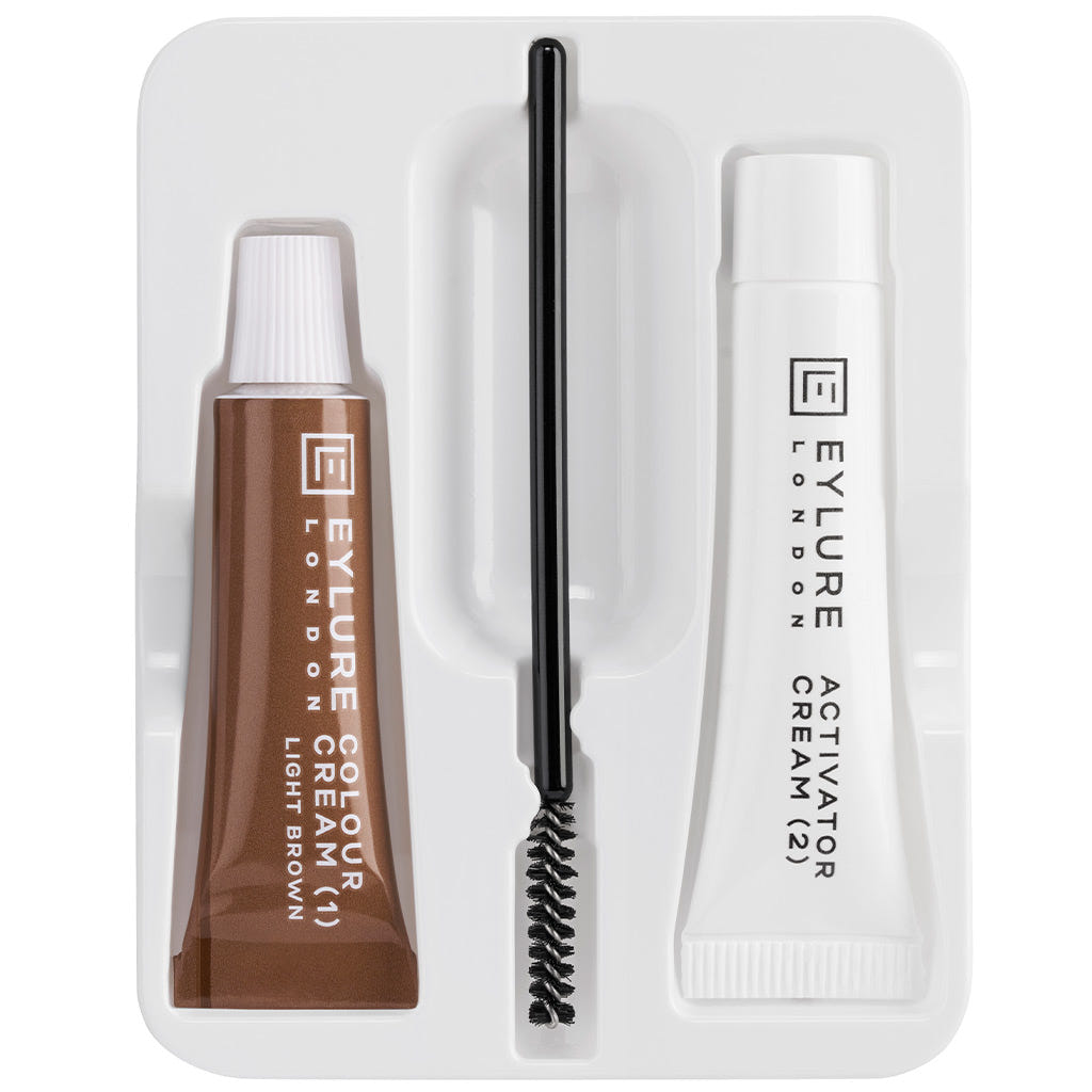 The Eylure Dybrow Permanent Eyebrow Tint in Light Brown provides a lasting tint experience, featuring a white activator and a stylish black applicator brush. These components are elegantly arranged in a white tray, adding sophistication to your eyebrow routine.
