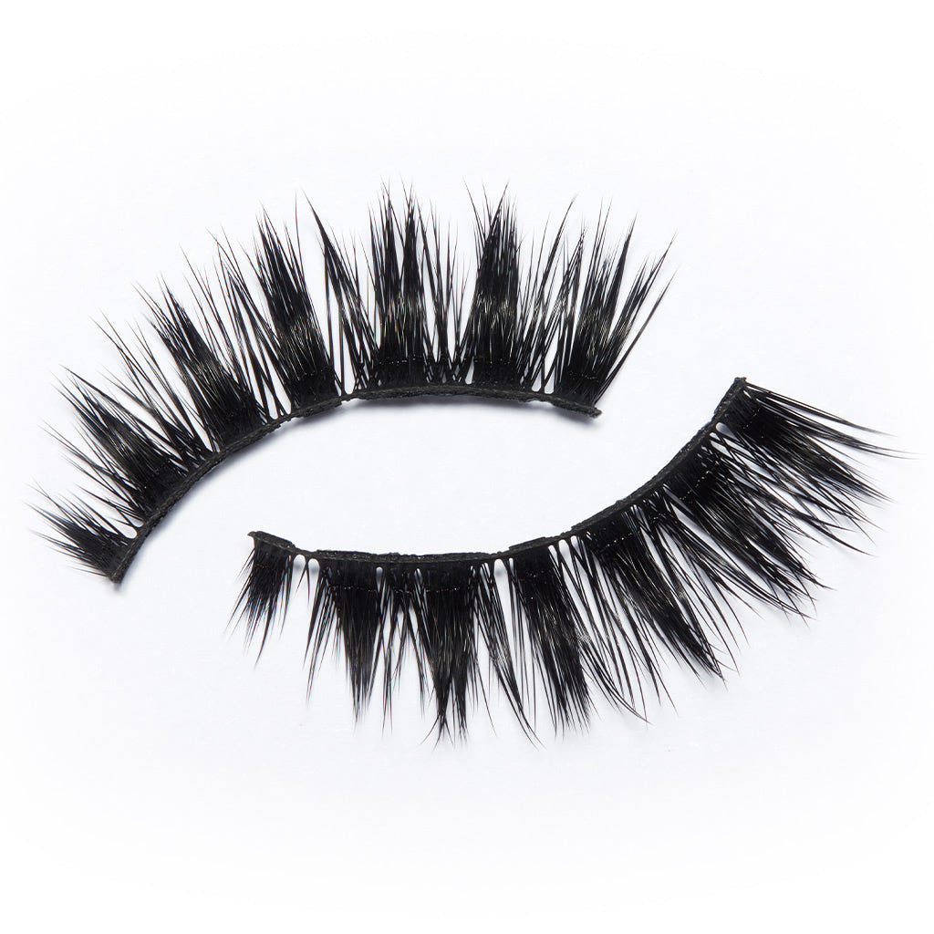 The Eylure Luxe Silk Lashes - Ascher offer a dramatic look with their thick, voluminous, and spiked black fibers. They are designed in a curved shape on a white background to create a striking winged-out finish.