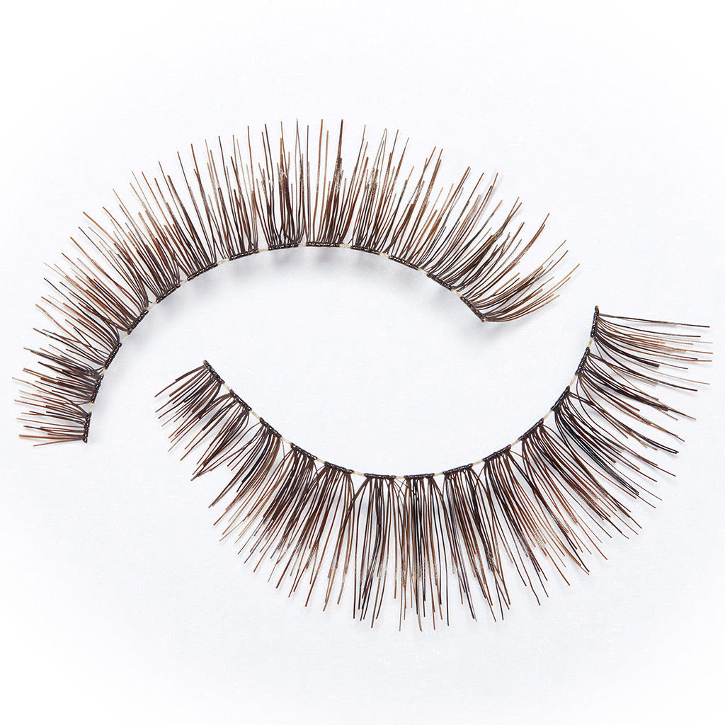 The Eylure Pre-Glued Volume Lashes 100, featuring long, dark brown strands, are displayed on a plain white background. They provide a fuller appearance at the base and gracefully taper towards the ends for a natural look.