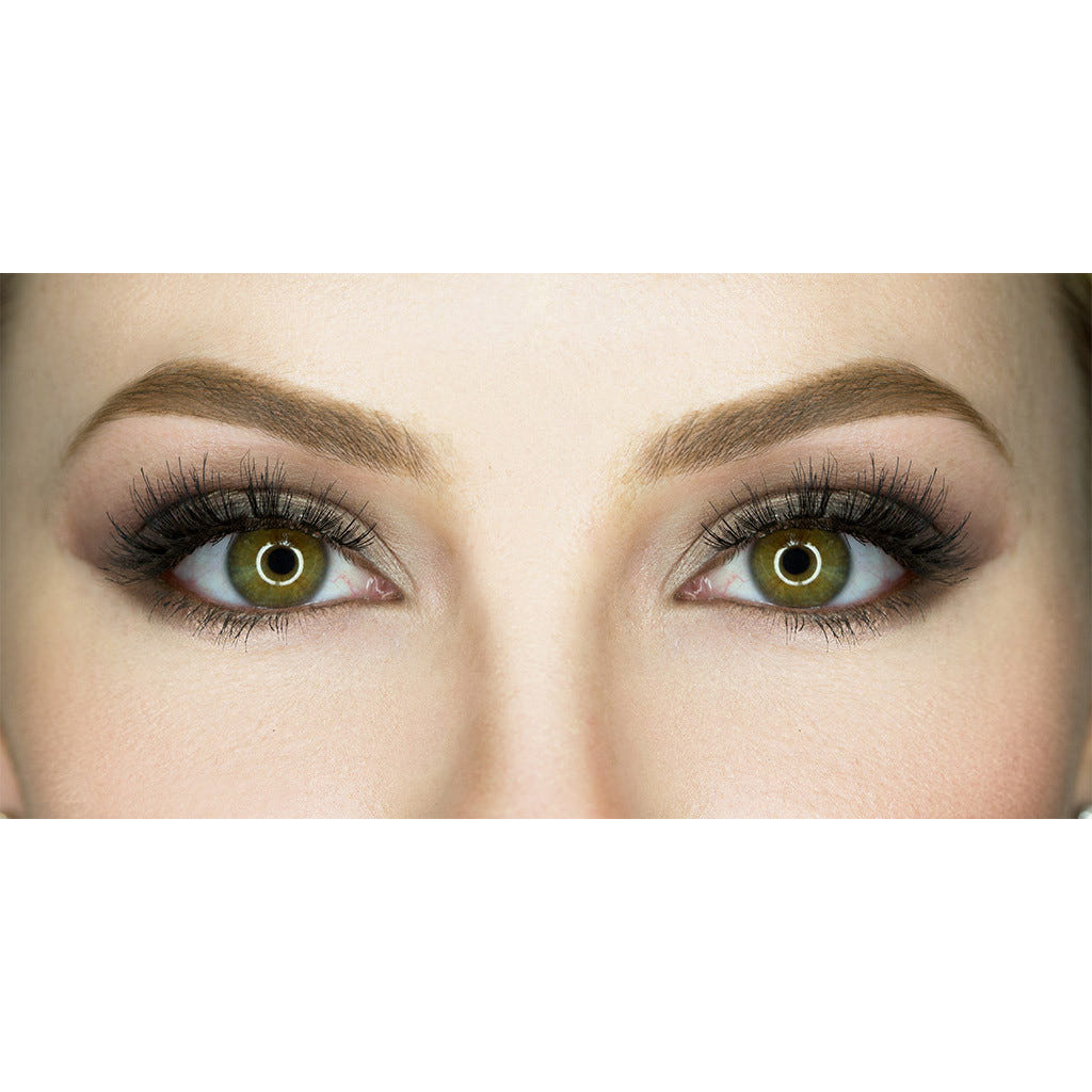 Close-up of a person's eyes with bright light reflections in the pupils. The surrounding makeup includes dark eyeliner and long, dramatic Siren eyelashes from House of Lashes, with well-groomed eyebrows. The skin is smooth and evenly toned.