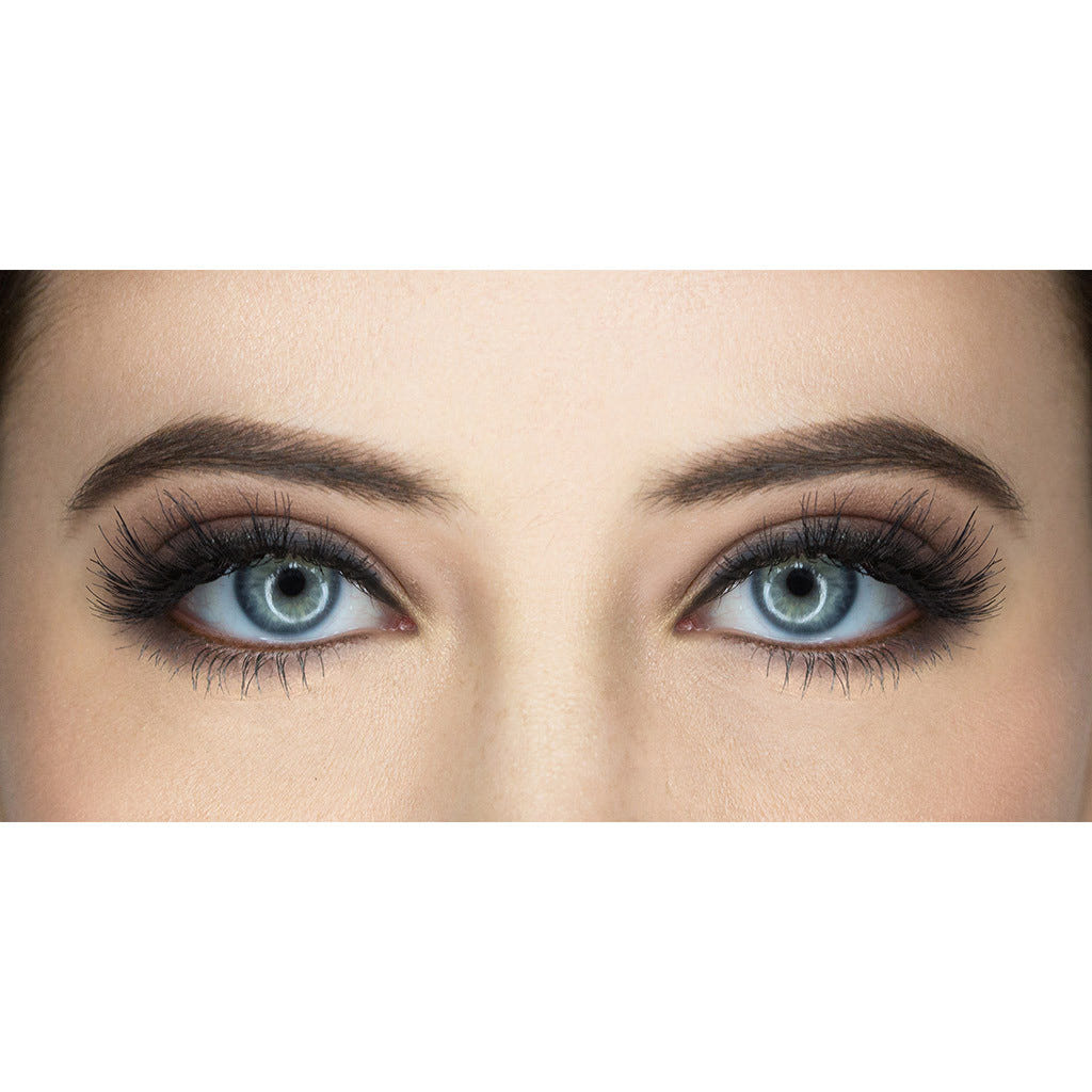 A close-up of a person's eyes featuring blue irises and thick, well-defined eyebrows. The dramatic Siren eyelashes by House of Lashes are made from 100% human hair, adding length and volume. These exquisite false lashes are complemented by dark, smoky eye makeup that enhances the eyes' appearance.